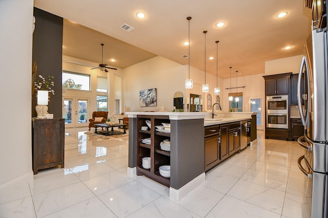 kitchen featuring visible vents, marble finish floor, open floor plan, and stainless steel appliances