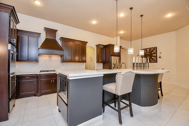 kitchen with stainless steel appliances, backsplash, marble finish floor, and custom range hood