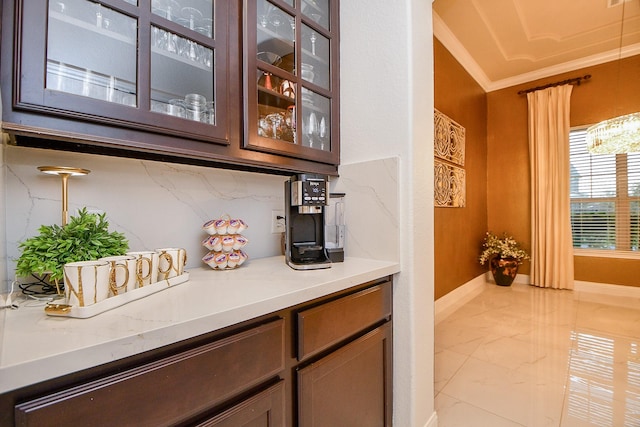 bar with decorative backsplash, crown molding, baseboards, and marble finish floor