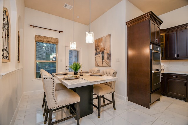 dining room with visible vents, baseboards, and marble finish floor