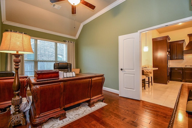 office area with visible vents, wood finished floors, crown molding, ceiling fan, and vaulted ceiling