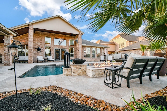 view of swimming pool with a fenced in pool, fence, a fire pit, and a patio area