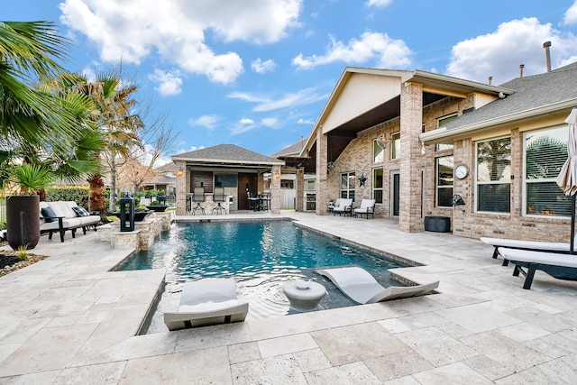 view of swimming pool featuring a fenced in pool, a patio, an outdoor structure, and outdoor dry bar