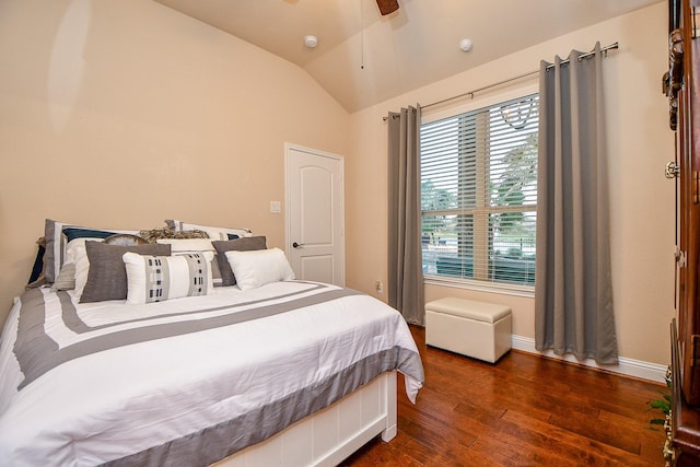 bedroom with a ceiling fan, vaulted ceiling, wood finished floors, and baseboards