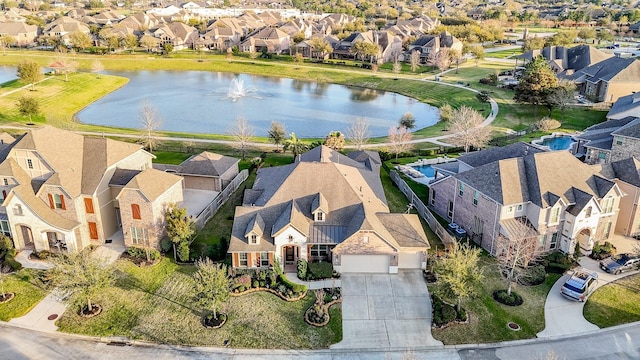 drone / aerial view featuring a residential view and a water view