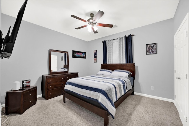 bedroom with carpet, baseboards, and a ceiling fan