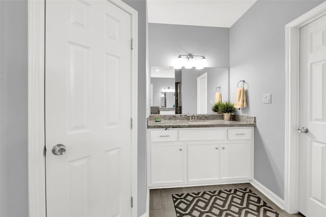 bathroom featuring vanity and baseboards