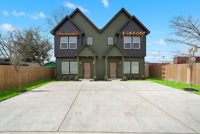 view of front of property with board and batten siding and fence