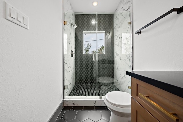 bathroom featuring toilet, a stall shower, tile patterned flooring, and a textured wall