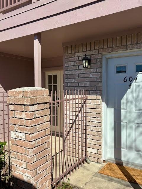 doorway to property featuring brick siding