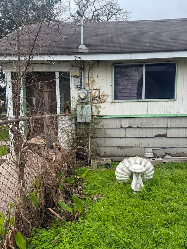 view of property exterior featuring roof with shingles