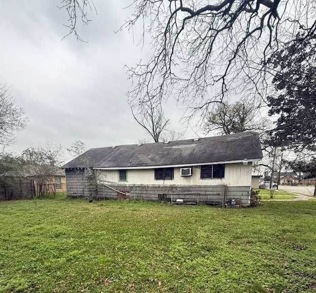 back of property with fence and a yard