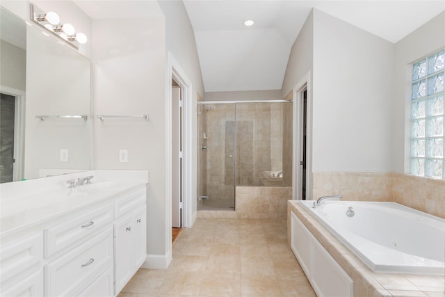 bathroom featuring vaulted ceiling, a shower stall, vanity, a whirlpool tub, and tile patterned floors