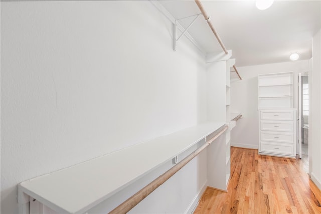 walk in closet featuring light wood finished floors