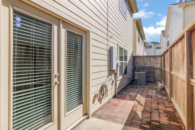 exterior space featuring a patio area, central AC, and fence