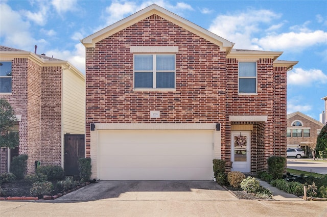 view of front of property featuring a garage, concrete driveway, and brick siding