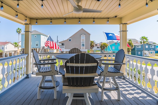 deck featuring a residential view and a ceiling fan