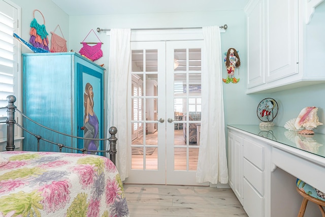 bedroom with french doors and light wood-style floors