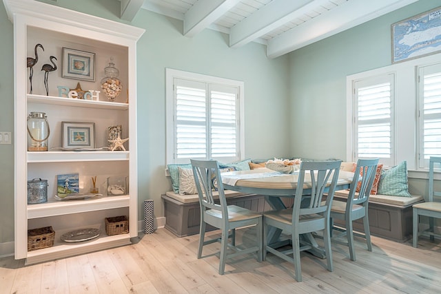 dining room featuring beamed ceiling and wood finished floors