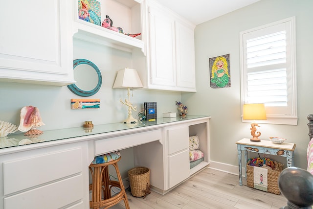 interior space featuring light countertops, light wood-type flooring, white cabinets, and open shelves