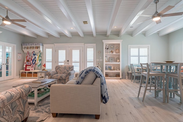 living area with light wood-style floors, french doors, ceiling fan, and beam ceiling