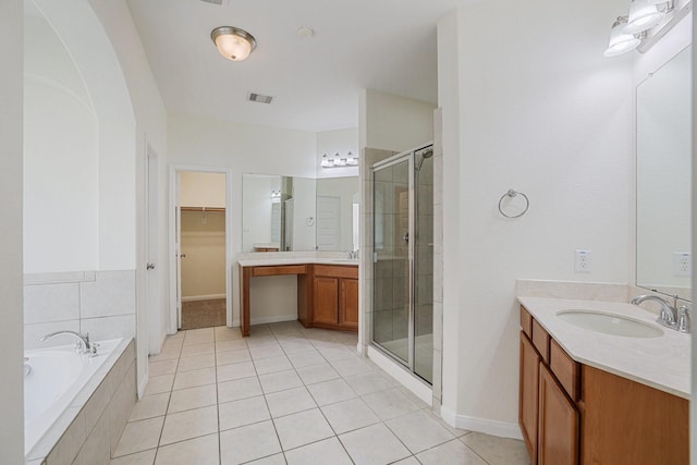 full bath featuring a stall shower, visible vents, a spacious closet, vanity, and a bath