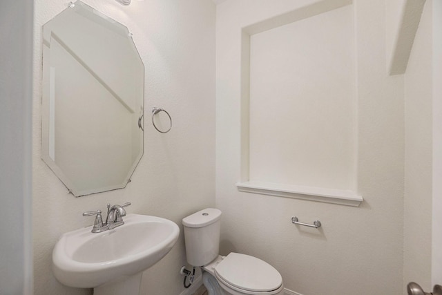 bathroom with toilet and a sink