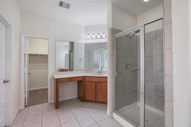 bathroom with a stall shower, tile patterned flooring, and visible vents