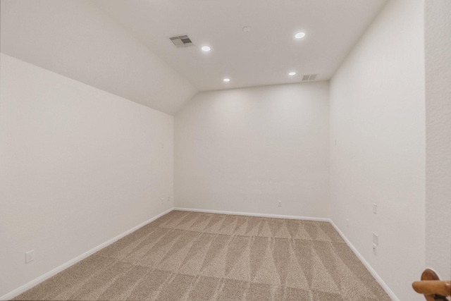 additional living space with light carpet, baseboards, visible vents, and recessed lighting