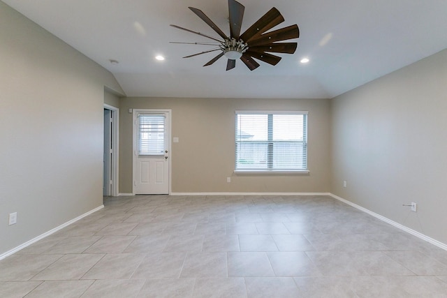 empty room featuring baseboards, vaulted ceiling, and recessed lighting