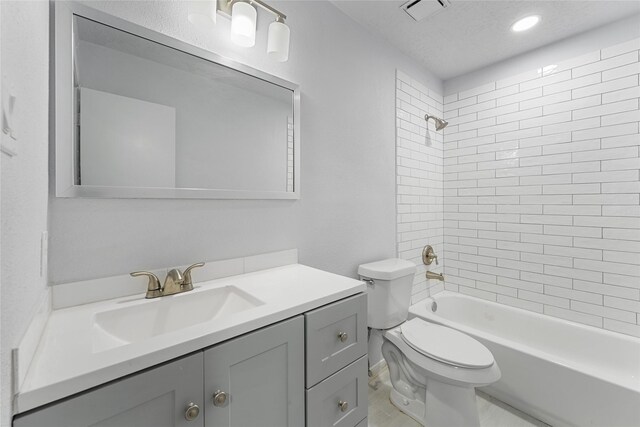 bathroom featuring visible vents, bathing tub / shower combination, toilet, a textured ceiling, and vanity