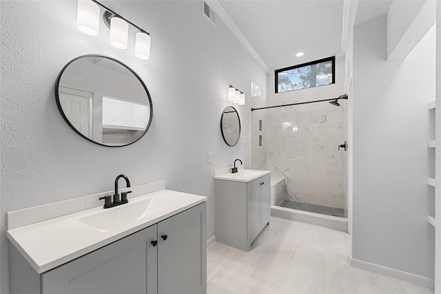 bathroom featuring ornamental molding, two vanities, a sink, and a shower stall