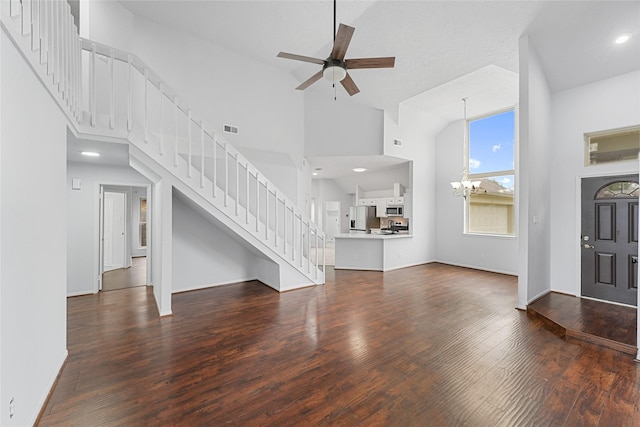 unfurnished living room with stairs, visible vents, and wood finished floors