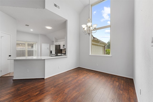 kitchen with dark wood-style flooring, visible vents, white cabinetry, vaulted ceiling, and stainless steel fridge with ice dispenser