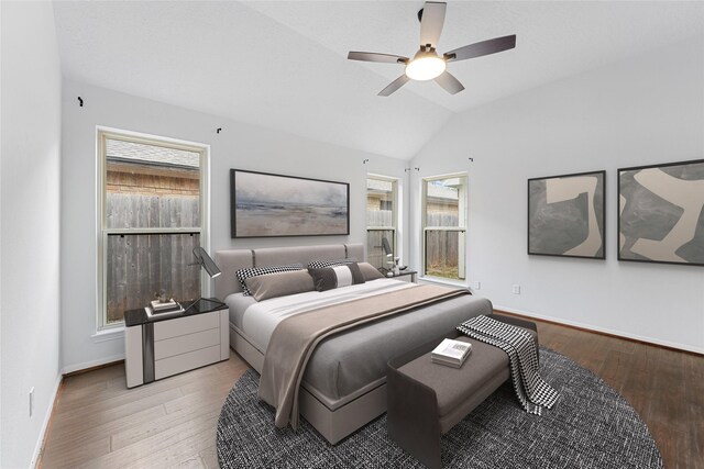 bedroom featuring lofted ceiling, ceiling fan, baseboards, and wood finished floors