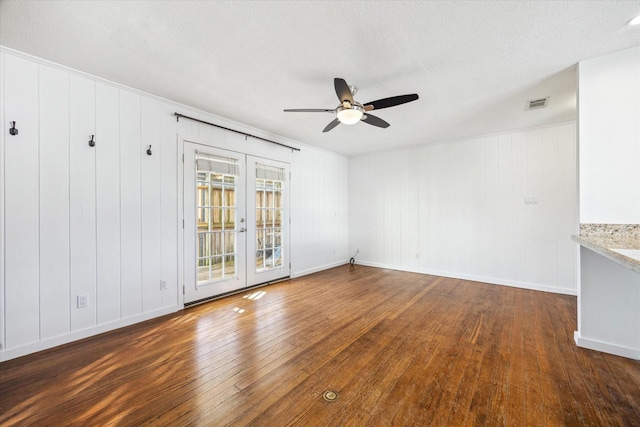 spare room with ceiling fan, visible vents, baseboards, french doors, and wood-type flooring