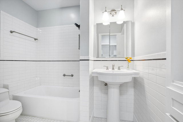 full bathroom with bathing tub / shower combination, tile patterned flooring, toilet, and tile walls