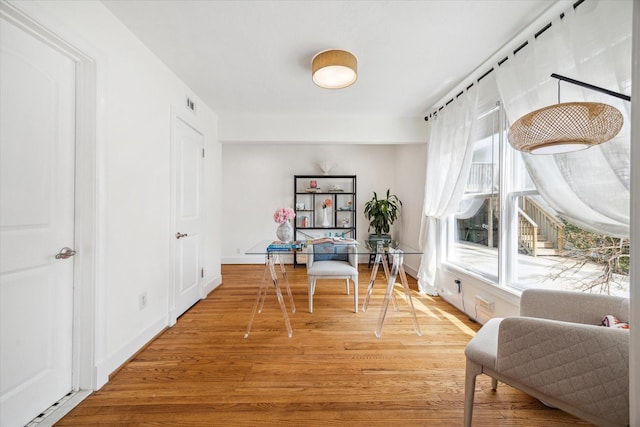 home office featuring baseboards, visible vents, and light wood-style floors