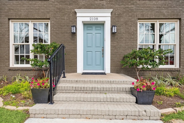 view of exterior entry with brick siding