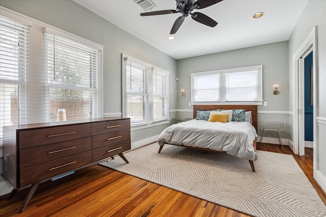 bedroom featuring recessed lighting, visible vents, baseboards, and wood finished floors