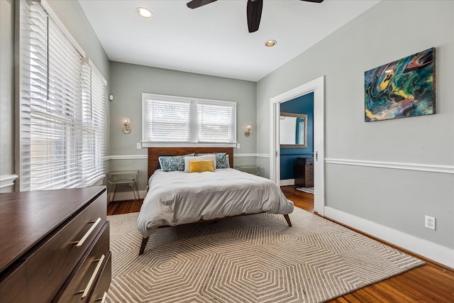 bedroom featuring ensuite bathroom, recessed lighting, wood finished floors, and baseboards