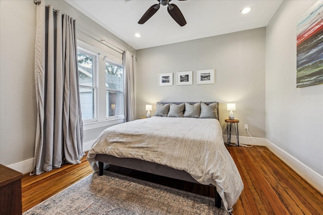 bedroom featuring dark wood-type flooring, recessed lighting, a ceiling fan, and baseboards