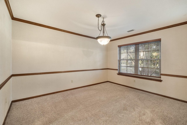 empty room featuring ornamental molding, carpet flooring, visible vents, and baseboards