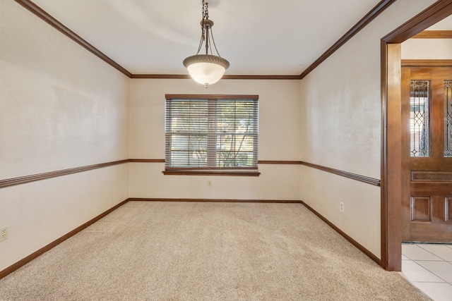 unfurnished room featuring carpet, baseboards, and crown molding