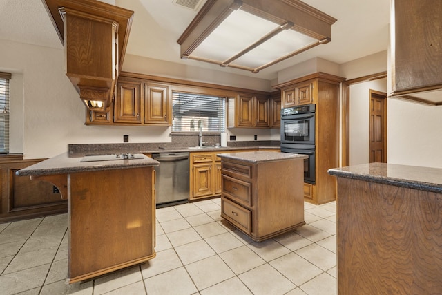 kitchen with dobule oven black, light tile patterned floors, dishwasher, a peninsula, and a sink