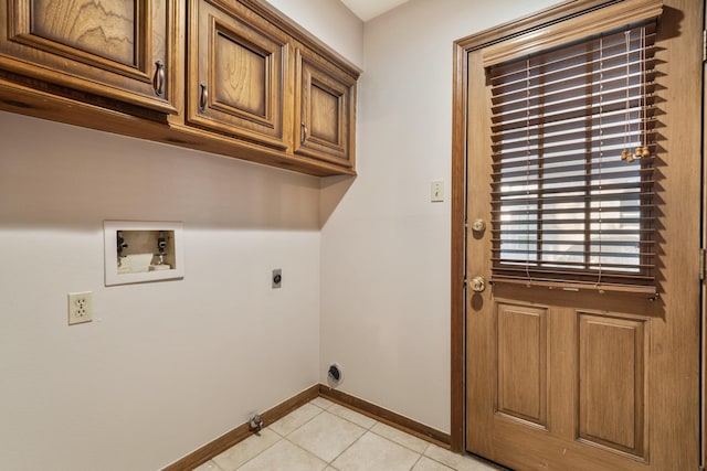 laundry room with cabinet space, baseboards, washer hookup, electric dryer hookup, and light tile patterned flooring