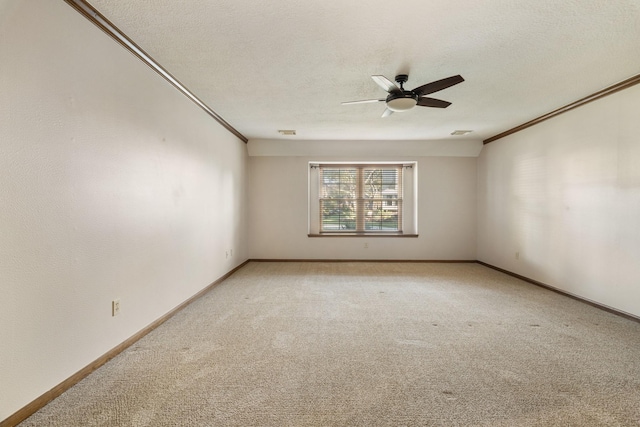 unfurnished room featuring light colored carpet, crown molding, and a textured ceiling