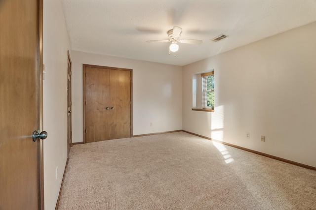 unfurnished bedroom featuring carpet, a closet, visible vents, and baseboards