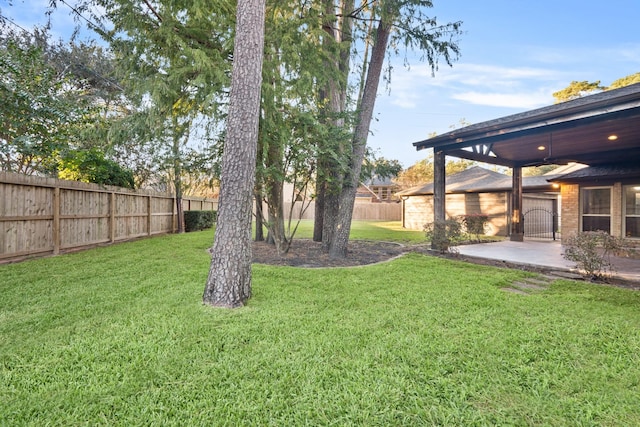 view of yard featuring fence and a patio