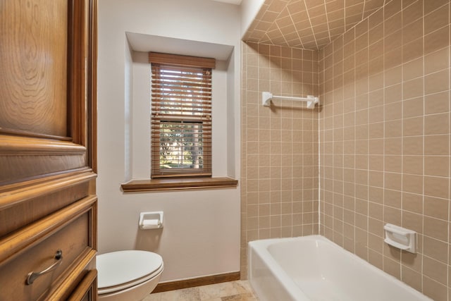 full bathroom with baseboards, shower / bathing tub combination, and toilet